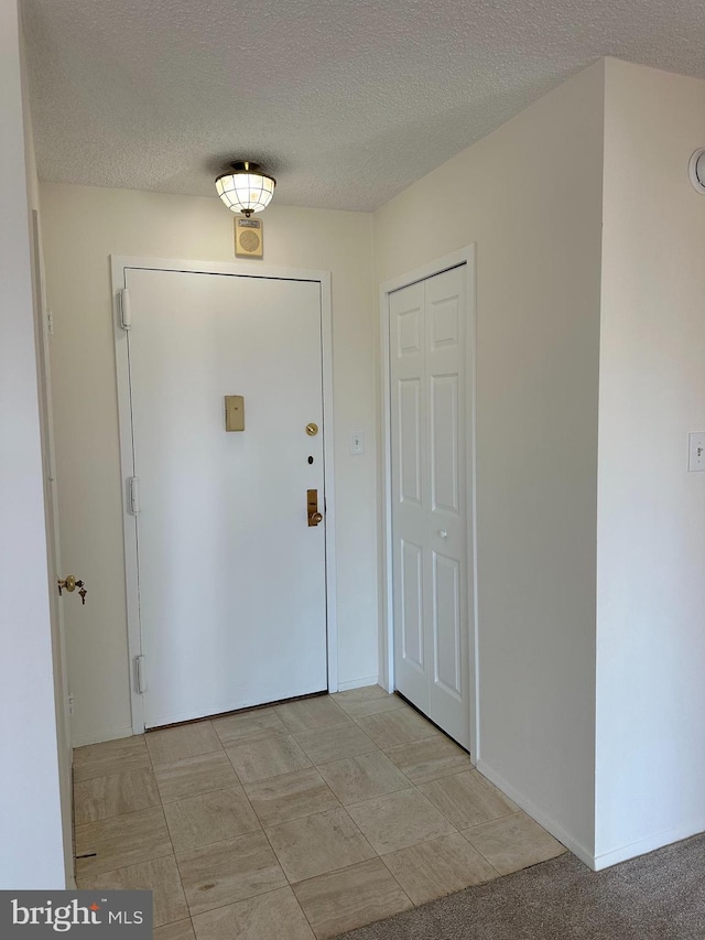 foyer featuring a textured ceiling