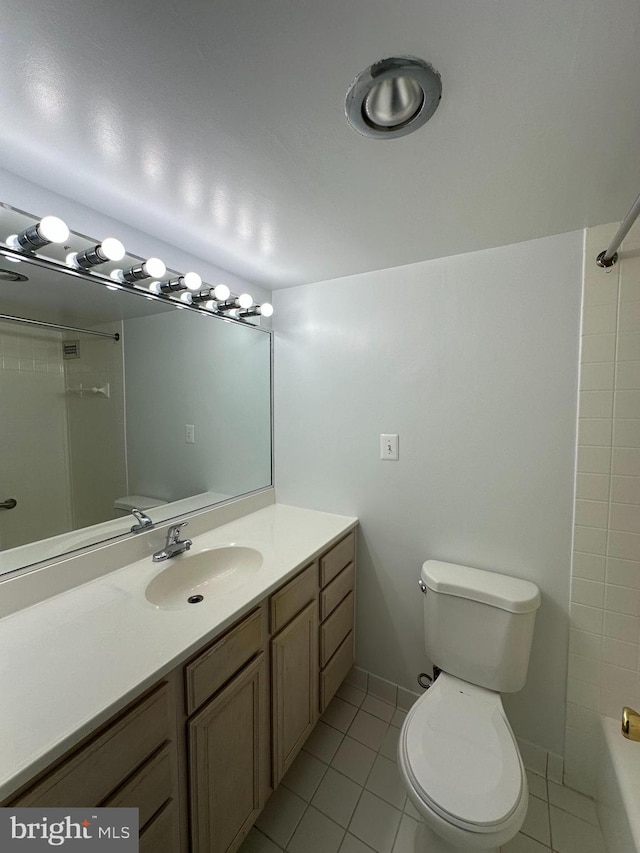 bathroom featuring shower / bathing tub combination, toilet, vanity, tile patterned flooring, and baseboards