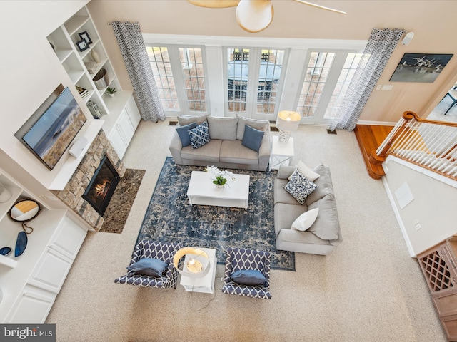 living room with a fireplace and baseboards