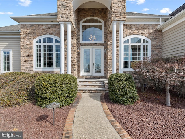 property entrance with french doors and roof with shingles