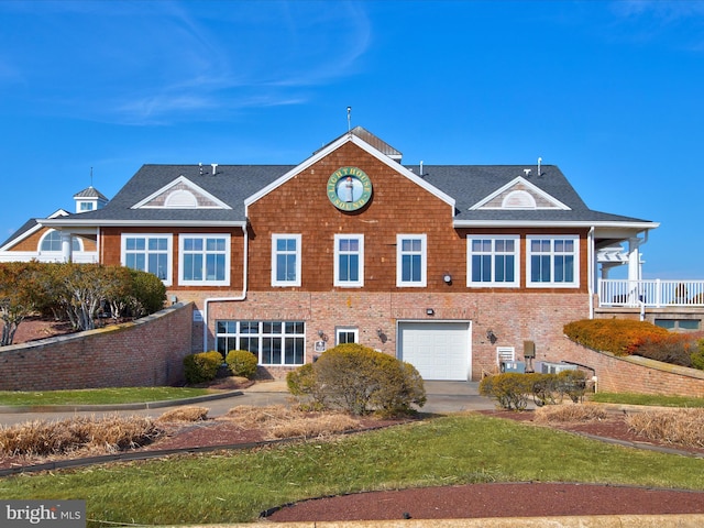 view of front facade featuring brick siding and an attached garage