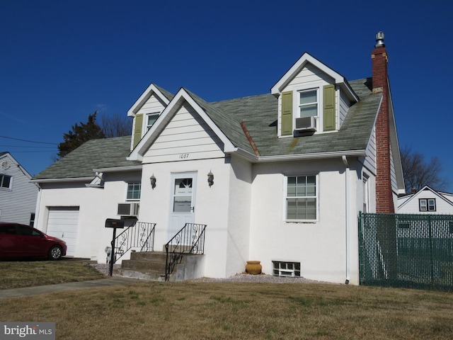 cape cod-style house with a garage, stucco siding, a chimney, fence, and a front yard