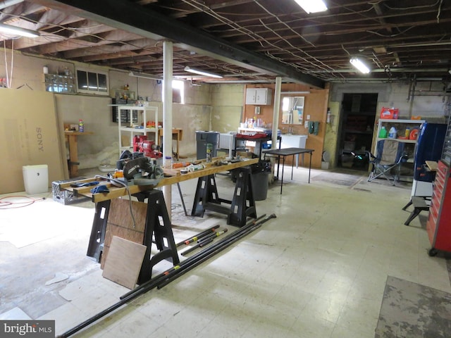 unfinished basement with a workshop area and tile patterned floors