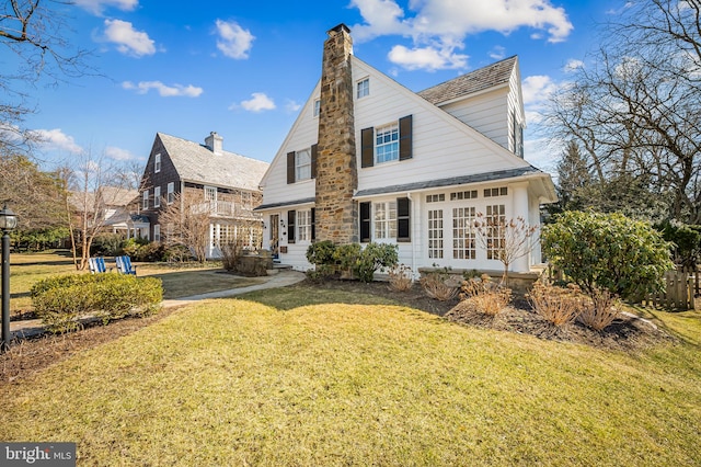 back of property featuring a lawn