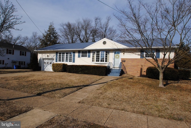 ranch-style house with a garage, driveway, and a front yard