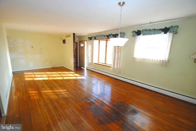 unfurnished room with hardwood / wood-style floors and baseboard heating