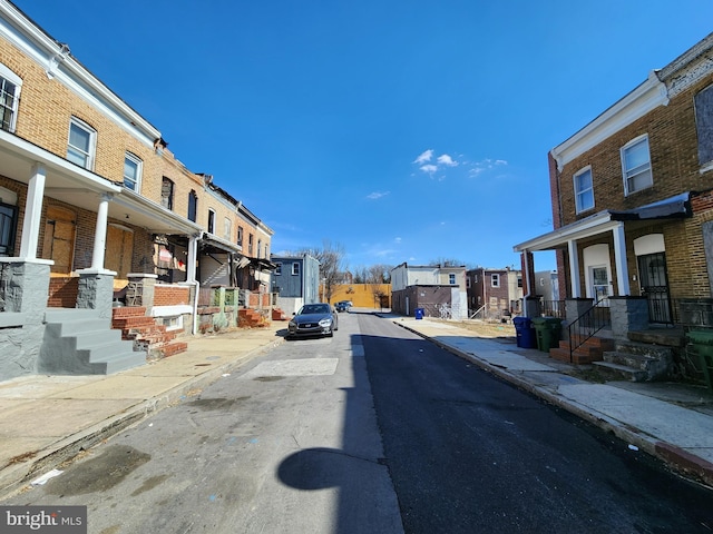 view of street featuring a residential view, curbs, and sidewalks