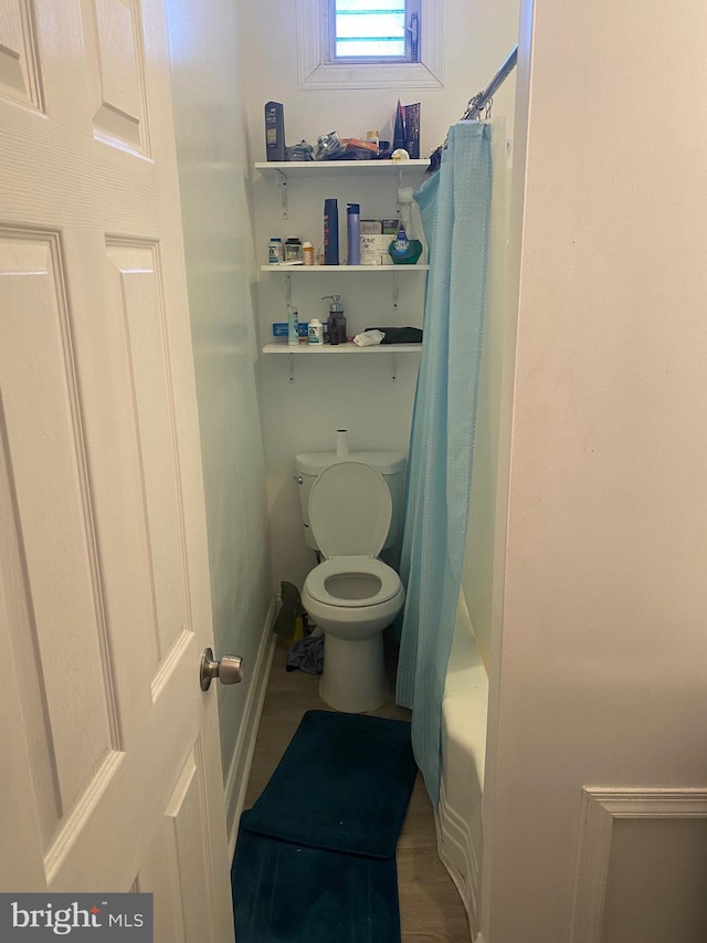 full bath featuring toilet and wood finished floors