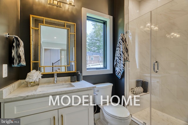 full bathroom featuring a stall shower, vanity, and toilet