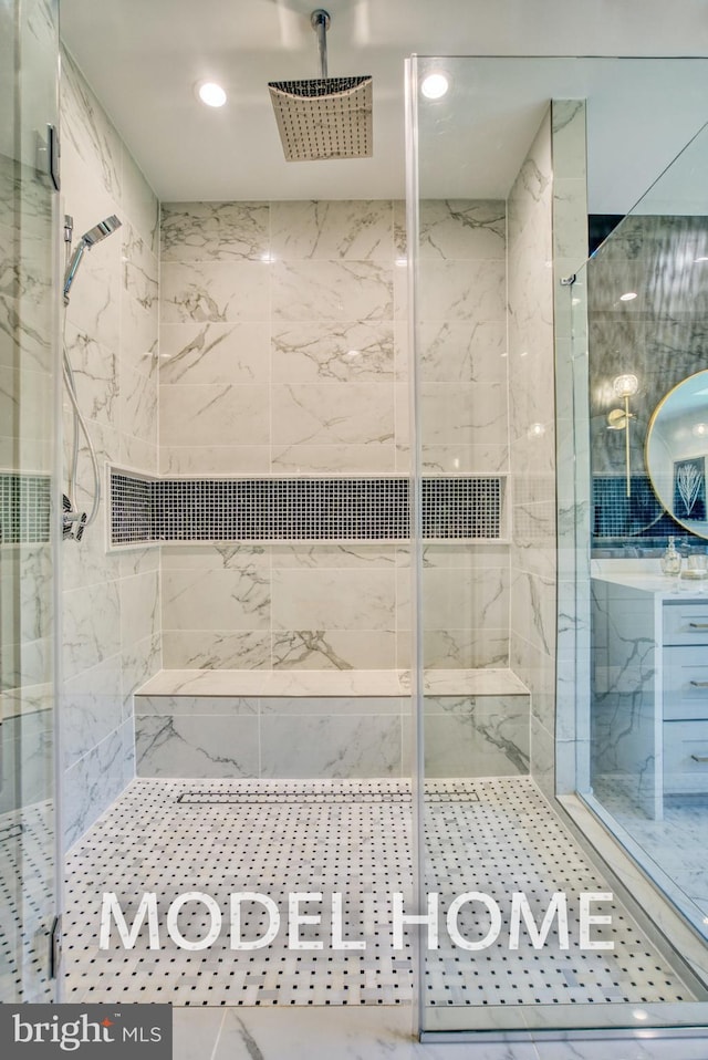 full bathroom with a marble finish shower and recessed lighting