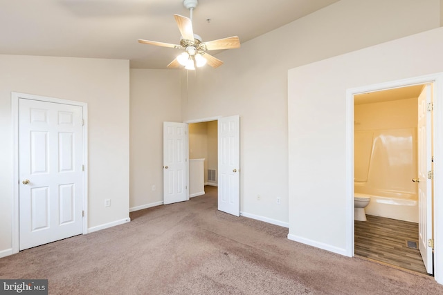 unfurnished bedroom featuring visible vents, baseboards, carpet, and ensuite bathroom