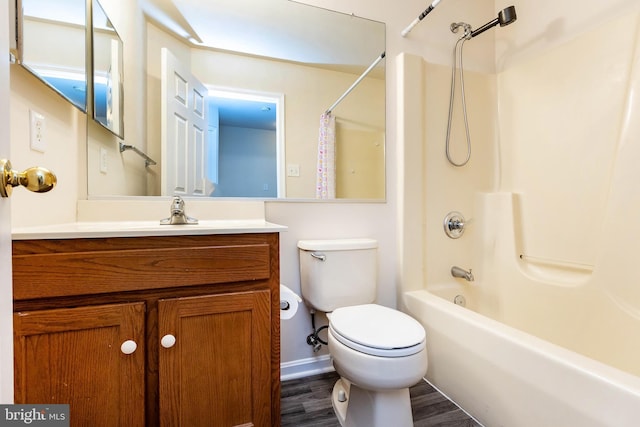 bathroom featuring shower / bathtub combination, toilet, wood finished floors, and vanity