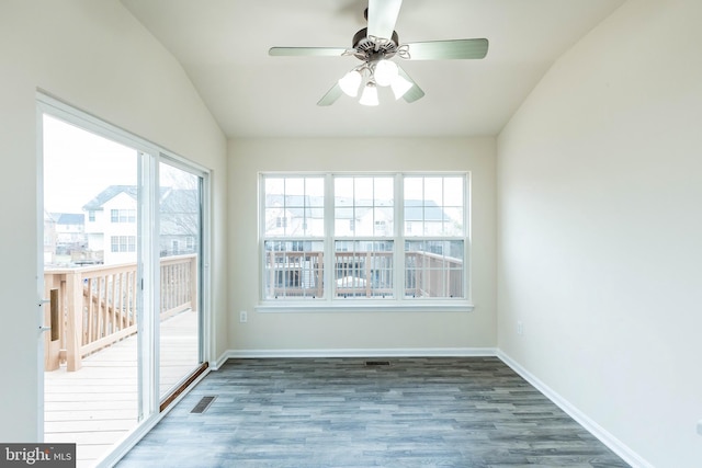 unfurnished sunroom with a wealth of natural light, visible vents, ceiling fan, and vaulted ceiling