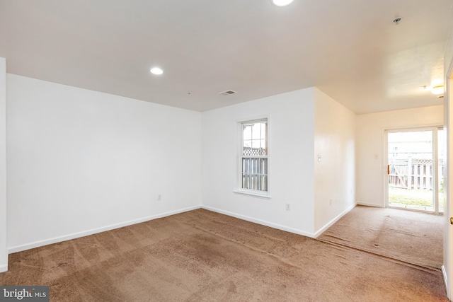 carpeted empty room with recessed lighting, visible vents, and baseboards