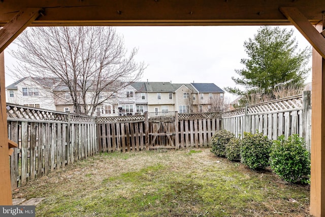 view of yard featuring a residential view and a fenced backyard