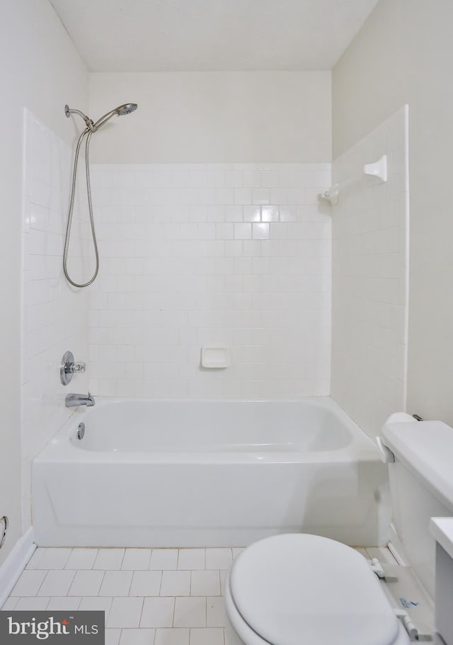 bathroom with tile patterned flooring, shower / tub combination, and toilet