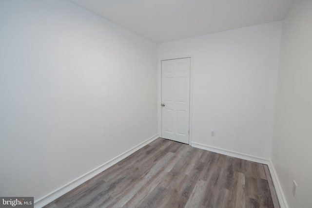 empty room featuring baseboards and wood finished floors