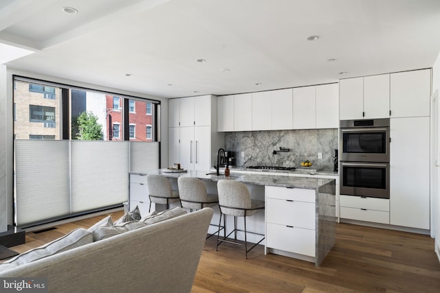 kitchen featuring modern cabinets, white cabinetry, and stainless steel appliances