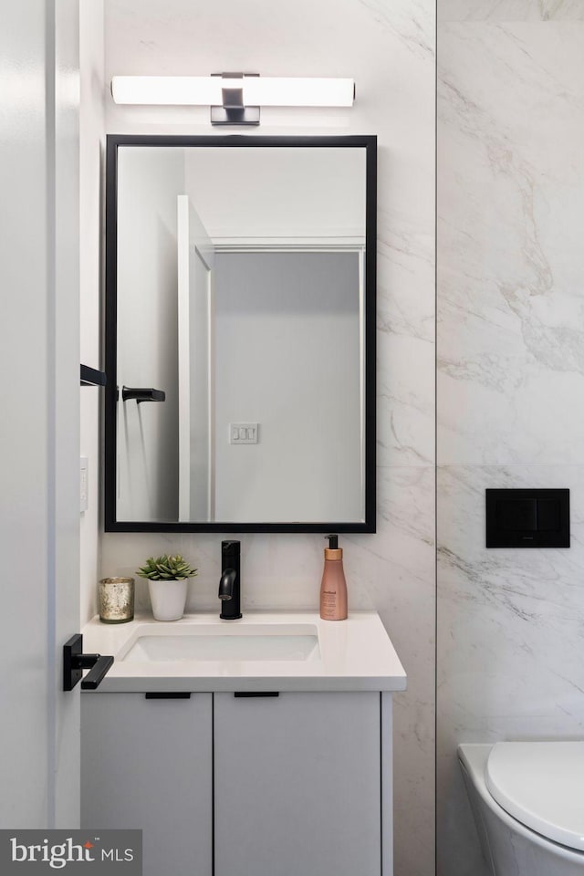 bathroom featuring toilet and vanity