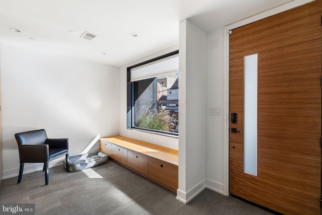 interior space featuring baseboards and visible vents