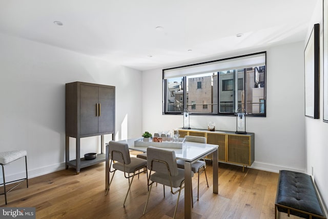 dining space with wood finished floors and baseboards