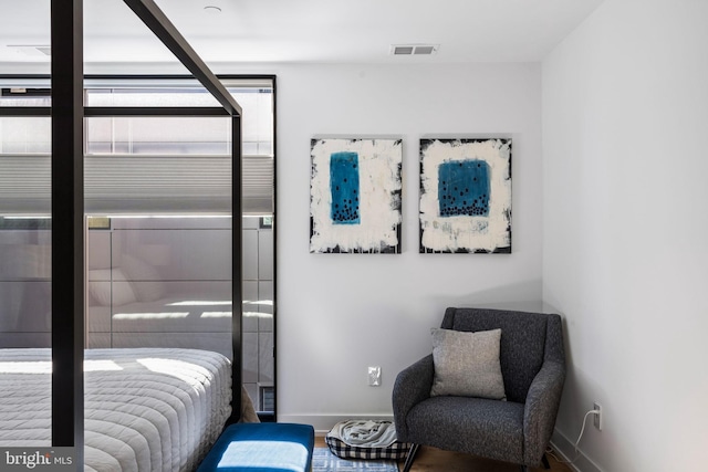 bedroom featuring visible vents, baseboards, and wood finished floors