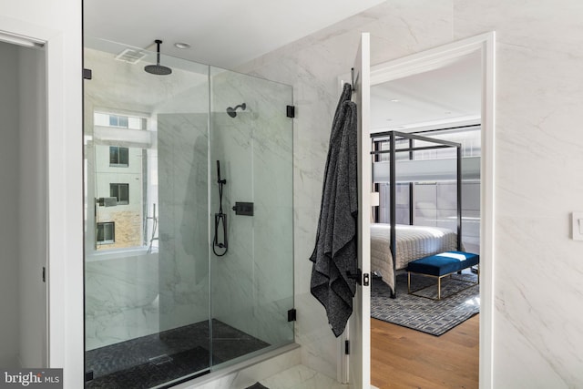 full bath with visible vents, wood finished floors, ensuite bath, and a marble finish shower