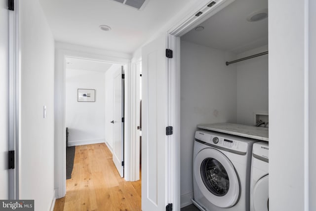 washroom featuring laundry area, light wood-type flooring, independent washer and dryer, and visible vents