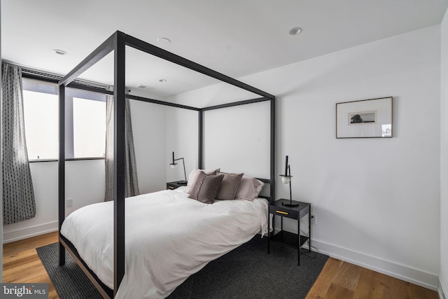 bedroom featuring baseboards and wood finished floors