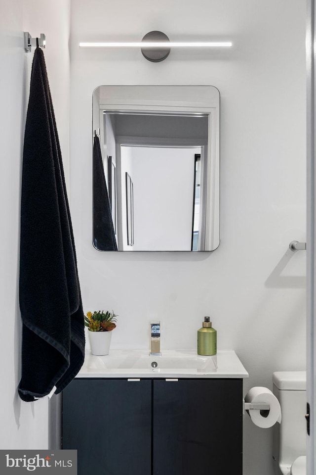 bathroom with toilet and vanity