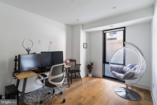 office area featuring light wood-style flooring and baseboards