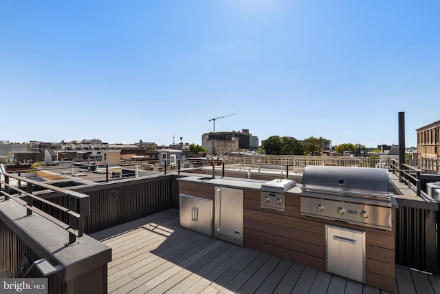 deck with exterior kitchen and grilling area