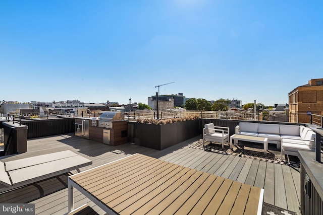 wooden deck featuring area for grilling and an outdoor living space