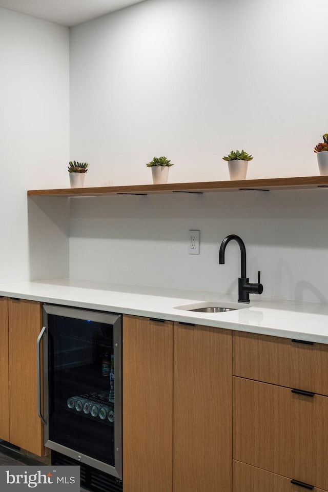 bar featuring wine cooler and a sink