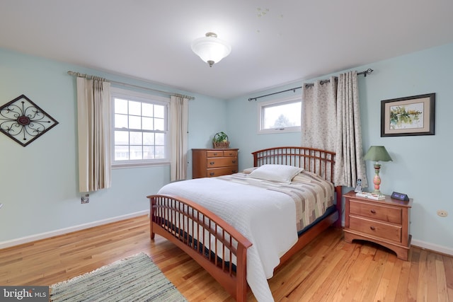 bedroom featuring light wood-style floors and baseboards