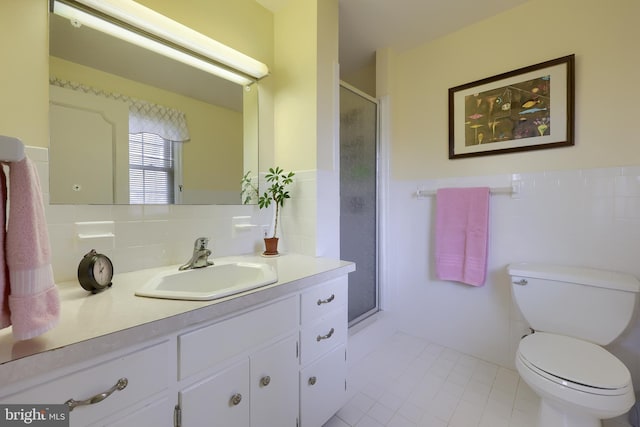 full bathroom with tile walls, a shower stall, vanity, and toilet