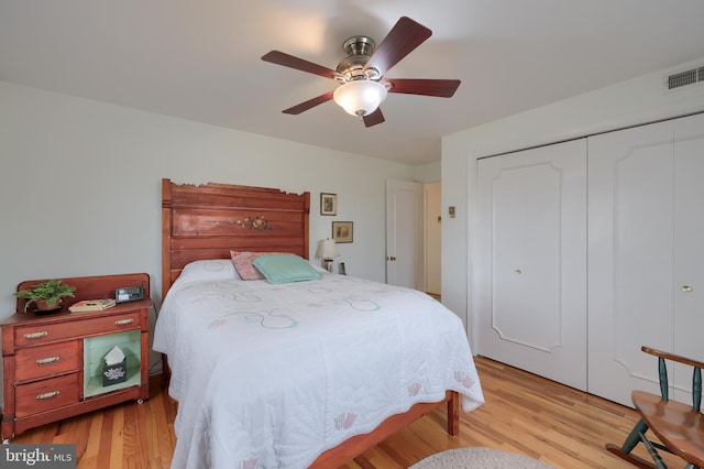 bedroom with a ceiling fan, light wood-type flooring, a closet, and visible vents