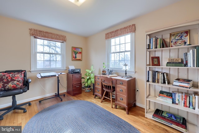 office space with baseboards and wood finished floors