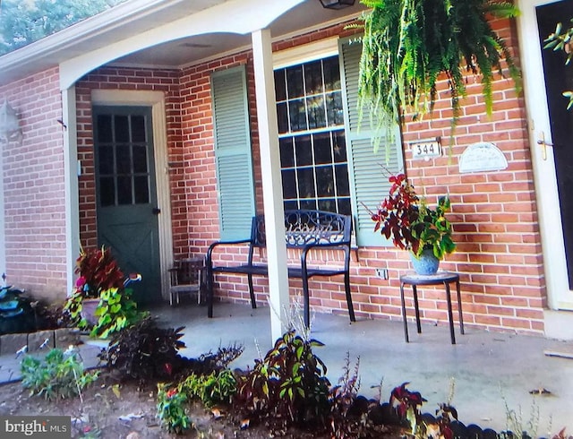 property entrance featuring brick siding