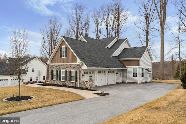 view of front of property featuring aphalt driveway, roof with shingles, a garage, stone siding, and a front lawn