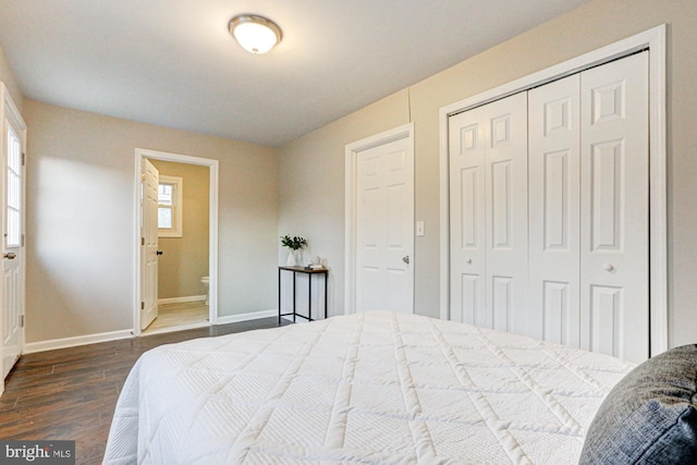 bedroom with ensuite bath, baseboards, a closet, and wood finished floors