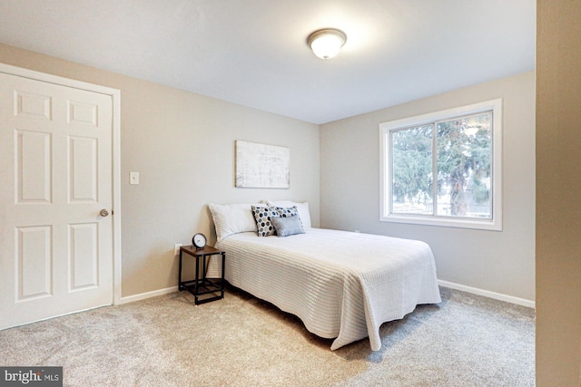 carpeted bedroom featuring baseboards