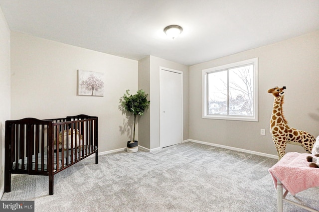 carpeted bedroom featuring baseboards