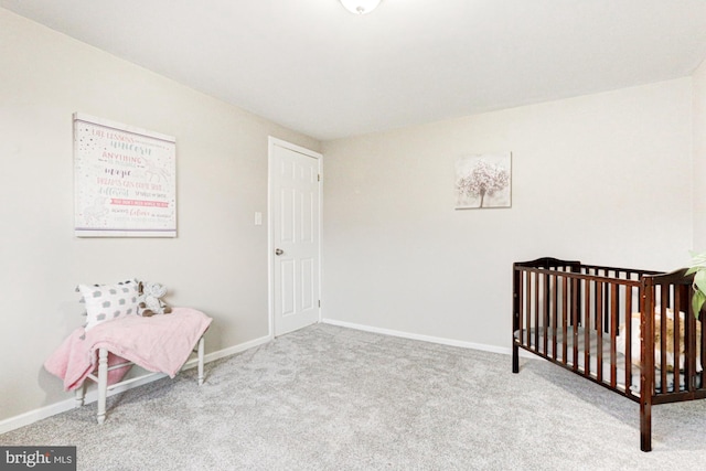 bedroom featuring carpet and baseboards