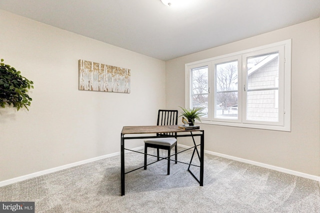 carpeted office space featuring baseboards