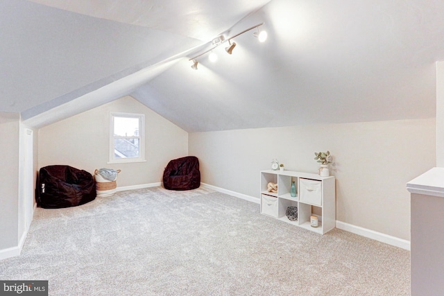 additional living space with lofted ceiling, carpet flooring, and baseboards