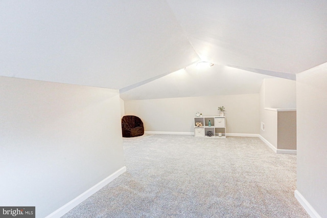 bonus room featuring carpet, vaulted ceiling, and baseboards