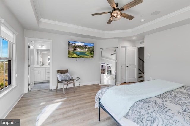 bedroom with light wood-style floors, visible vents, ornamental molding, and baseboards