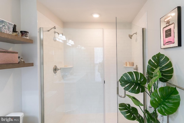 full bathroom with a shower stall and toilet