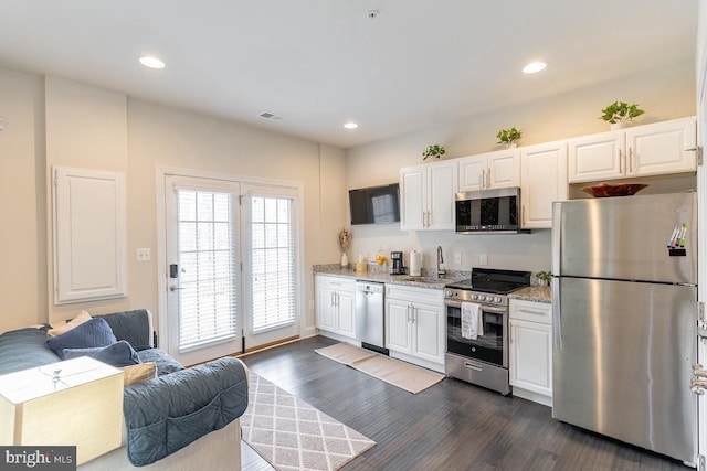 kitchen featuring white cabinetry, visible vents, appliances with stainless steel finishes, and dark wood-style flooring